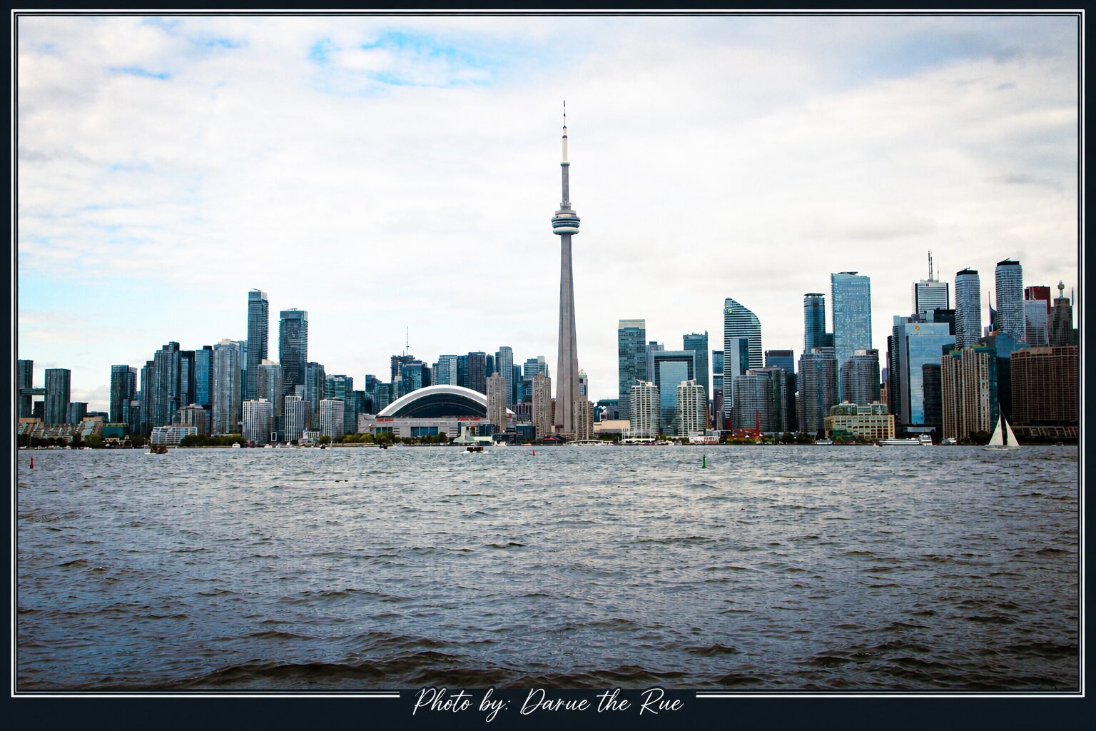 Toronto skyline with the CN Tower seen across the water from a boat